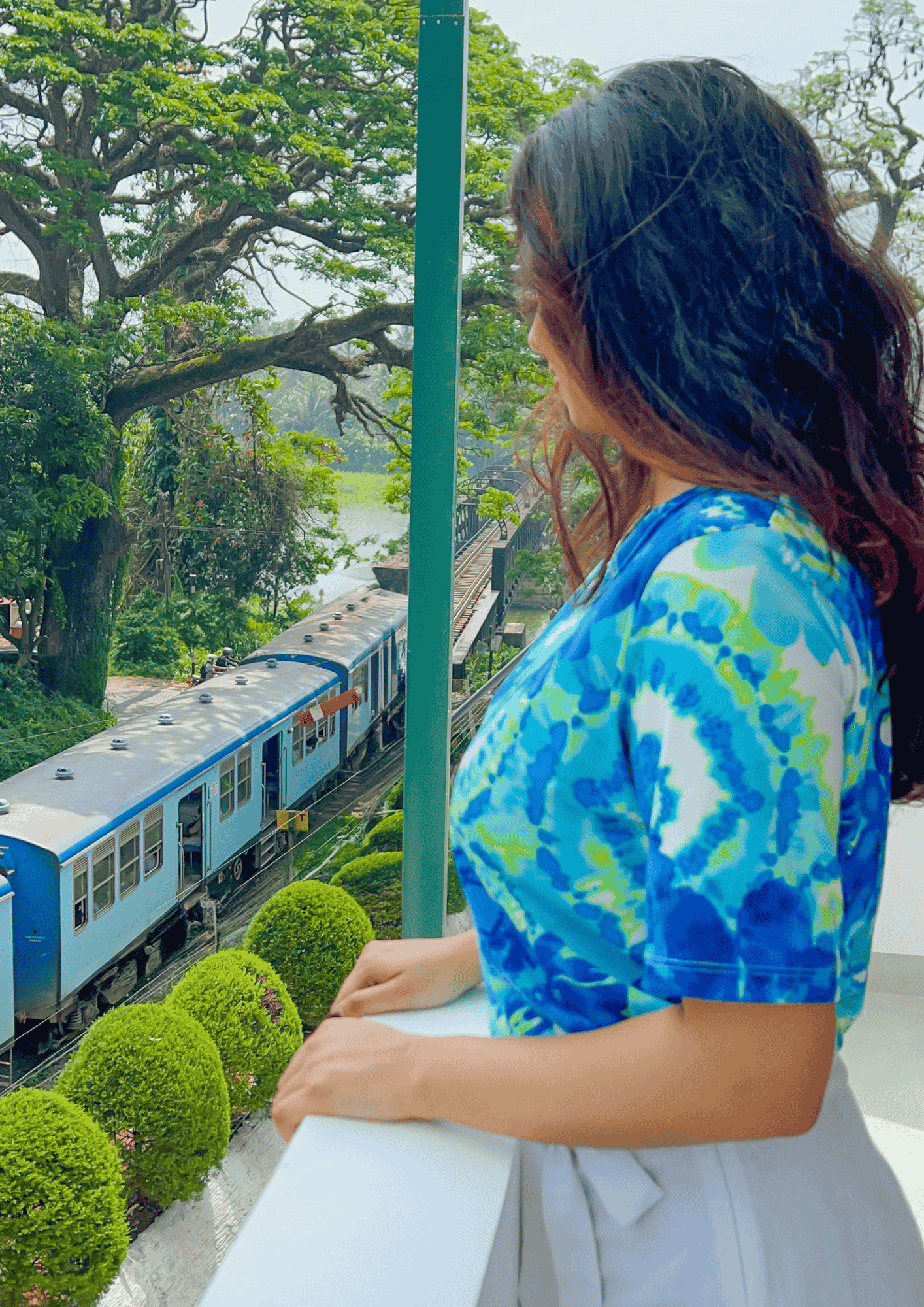 Woman looking down from the balcony
